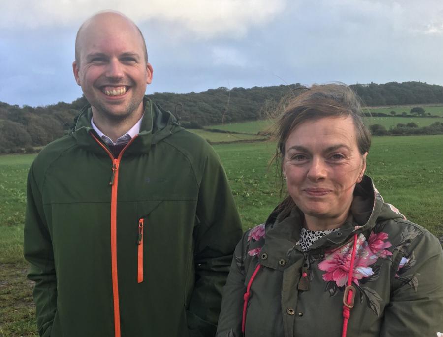 Two students stood side by side in the countryside