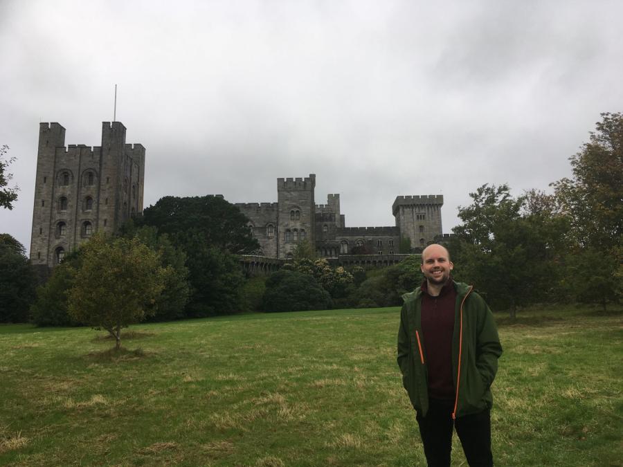 Photograph of Dr Matthew Rowland in front of Penrhyn Castle