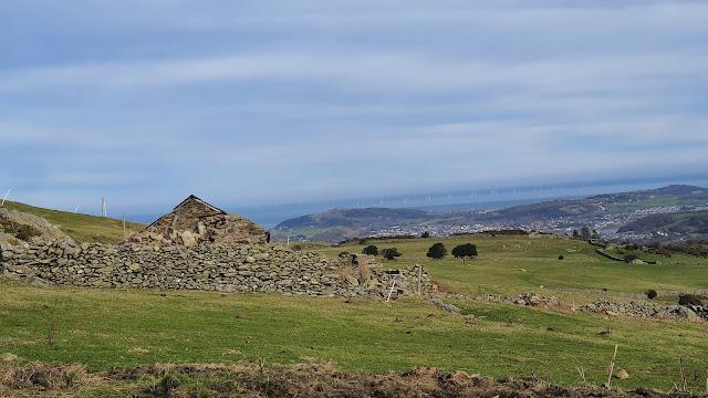 A ruined cottage in a mountain landscape