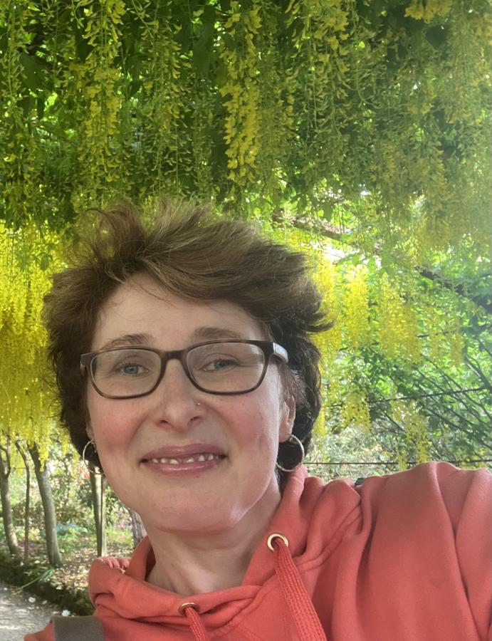 Photograph of Dr Mari Elin Wiliam in the laburnum arch at Bodnant Gardens.