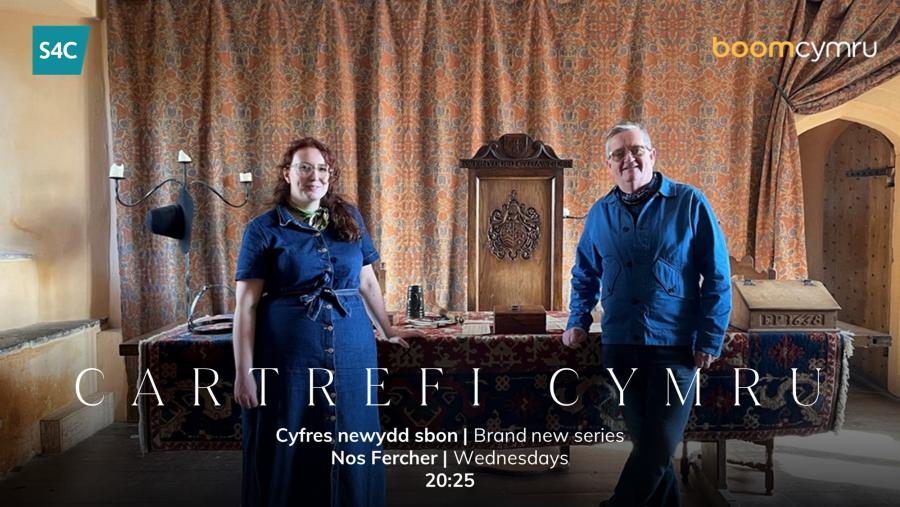 Presenters Aled and Bethan stand in front of a table in the Tudor Great Hall of Llancaiach Fawr.