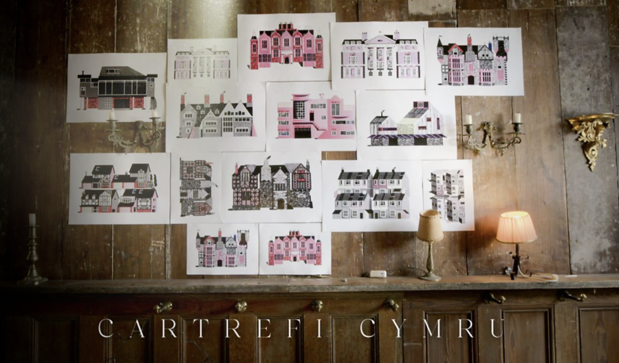 Still from the opening titles of 'Cartrefi Cymru' with colourful illustrations of houses from different periods displayed on a wooden panelled wall.