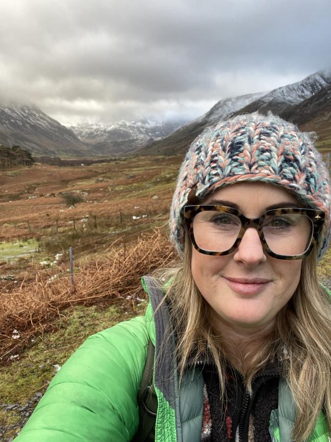 Headshot of KAte Jones with mountains in backdrop